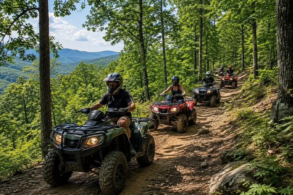 Riders on single-seat ATVs on a guided off-road trail in Pigeon Forge, Tennessee
